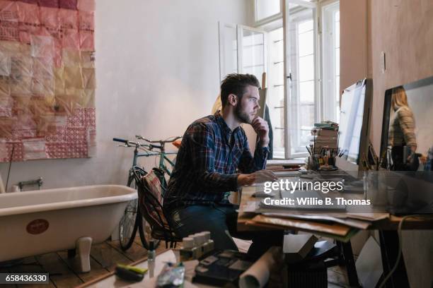young creative man working on computer - produit culturel photos et images de collection