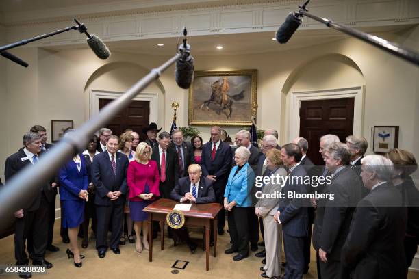 President Donald Trump, center, speaks during a bill signing ceremony in the Roosevelt Room of the White House in Washington, D.C., U.S., on Monday,...