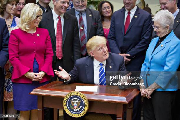 President Donald Trump speaks next to Representative Virginia Foxx, a Republican from North Carolina, right, and Representative Liz Cheney, a...