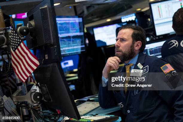 Traders work on the floor of the New York Stock Exchange ahead of the closing bell, March 27, 2017 in New York City. Today marked the eighth session...