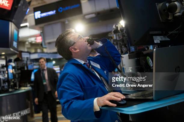 Traders work on the floor of the New York Stock Exchange ahead of the closing bell, March 27, 2017 in New York City. Today marked the eighth session...