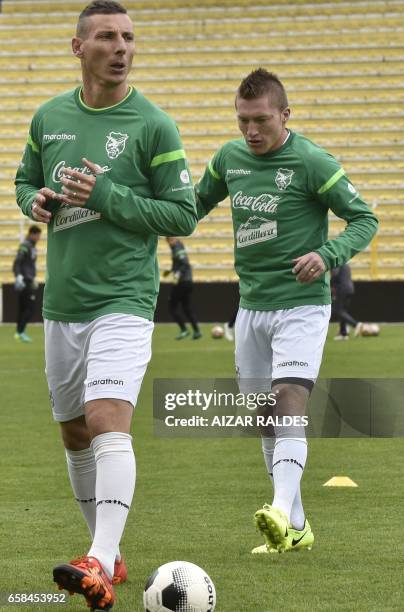 Bolivian players Alejandro Chumacero and Pablo Escobar take part in a training session on March 27 at the Hernando Siles stadium in La Paz. Bolivia...