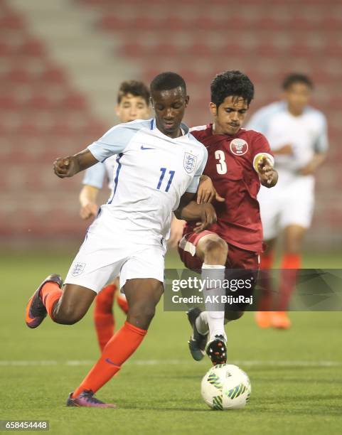 Ahmed Minhali of Qatar in action against Edward Nketiah of England during the U18 International friendly match between Qatar and England at the Grand...