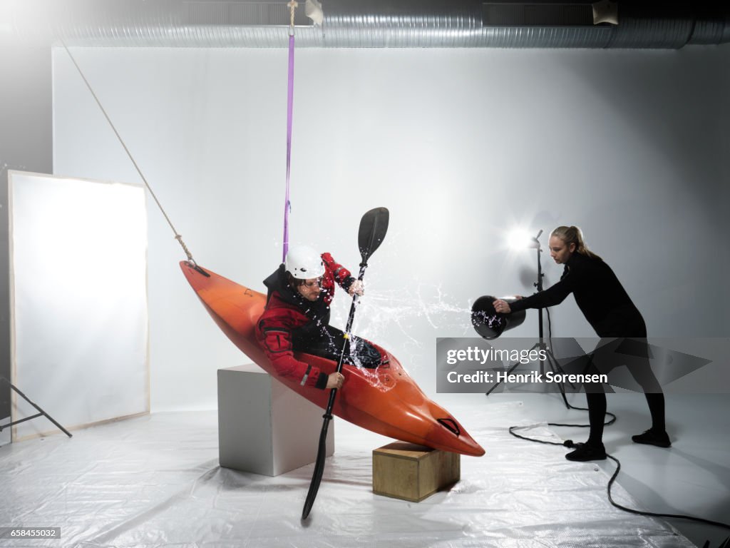 Male canoer being splashed in a studio