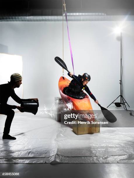 female canoer being splashed in a studio - sesion fotografica fotografías e imágenes de stock