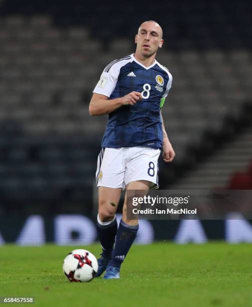 Scott Brown of Scotland controls the ball during the FIFA 2018 World Cup Qualifier between Scotland and Slovenia at Hampden Park on March 26, 2017 in...