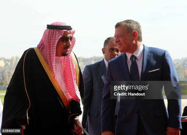 In this Handout photo released by the Jordanian Royal Court, King Abdullah II of Jordan welcomes King Salman bin Abdulaziz Al Saud of Saudi Arabia...