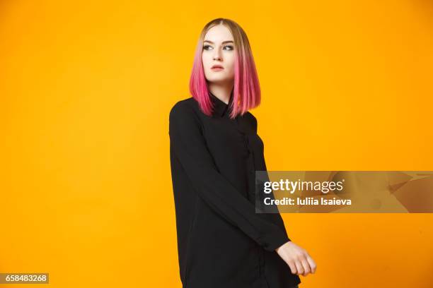 trendy female posing on orange - atelier mode stock-fotos und bilder