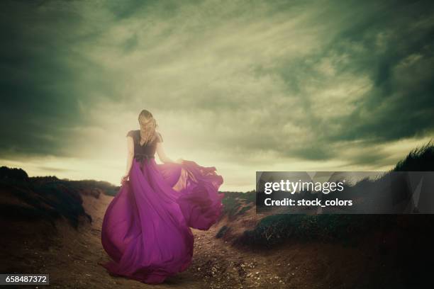 moments of silence - woman wearing purple dress stock pictures, royalty-free photos & images