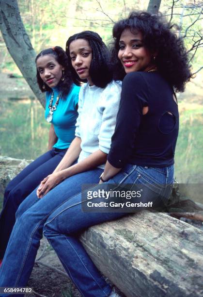 Portrait of three of the sibling Soul and Disco group Sister Sledge as they pose outdoors, Philadelphia, Pennsylvania, April 28, 1981. Pictured are,...