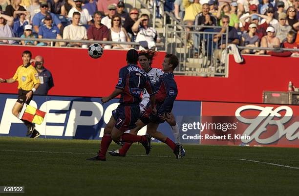 Ariel Graziani of the San Jose Earthquakes dribbles against the defense of Leo Cullen and Daniel Hernandez of the New England Revolution during the...