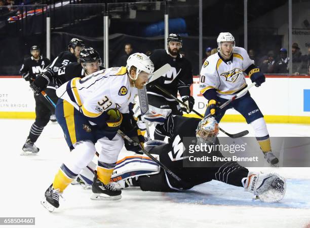 Thomas Greiss of the New York Islanders makes the first period save as Cody McLeod of the Nashville Predators looks for the rebound at the Barclays...