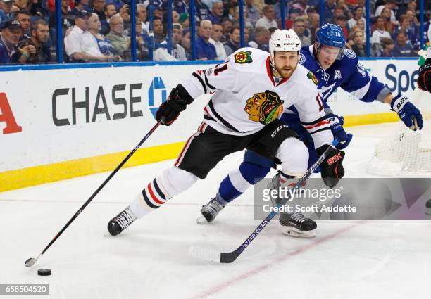 Ondrej Palat of the Tampa Bay Lightning skates against Andrew Desjardins of the Chicago Blackhawks during first period at Amalie Arena on March 27,...