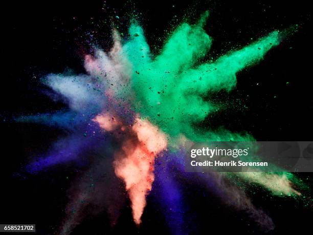 colorful powder explosion - blue green powder explosion stock pictures, royalty-free photos & images