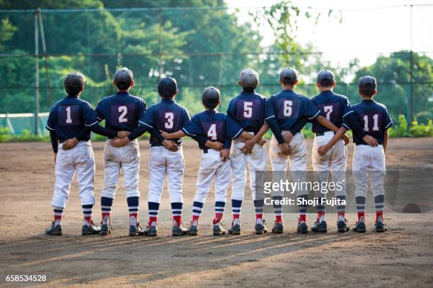 youth baseball players, teammates - arm in arm stock pictures, royalty-free photos & images