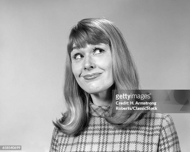 1960s WOMAN WITH LONG HAIR FLIP STYLE WITH BANGS LOOKING UP WITH AMUSED SMILE FACIAL EXPRESSION