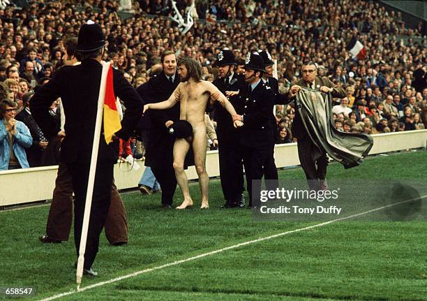 Streaker is arrested during the Five Nations match between England and Wales, in 1976, at Twickenham in London.