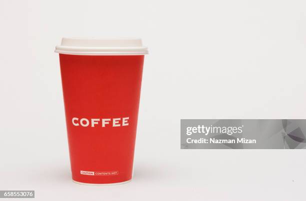 a red cup of coffee on white background. - mug stock-fotos und bilder