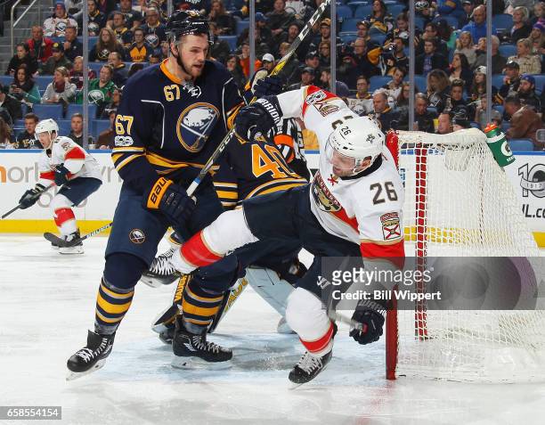 Brady Austin of the Buffalo Sabres upends Thomas Vanek of the Florida Panthers during an NHL game at the KeyBank Center on March 27, 2017 in Buffalo,...