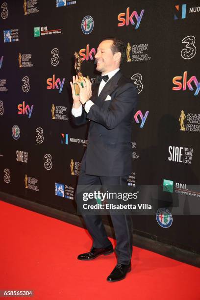 Actor Stefano Accorsi poses with his Best Actor Award during the 61. David Di Donatello ceremony on March 27, 2017 in Rome, Italy.