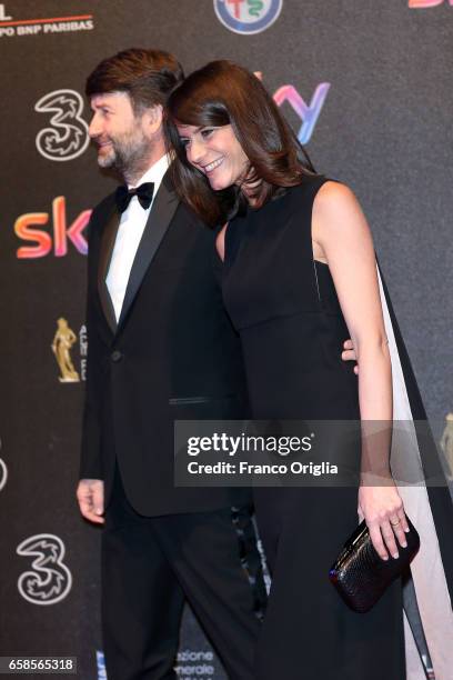 Dario Franceschini and a guest walk the red carpet of the 61. David Di Donatello on March 27, 2017 in Rome, Italy.