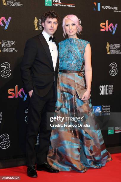 Michele Riondino and Eva Nestori walk the red carpet of the 61. David Di Donatello on March 27, 2017 in Rome, Italy.