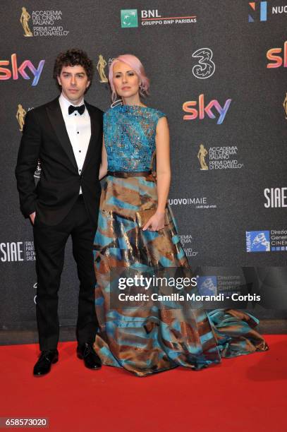 Michele Riondino and Eva Nestori walk the red carpet of the 61. David Di Donatello on March 27, 2017 in Rome, Italy.