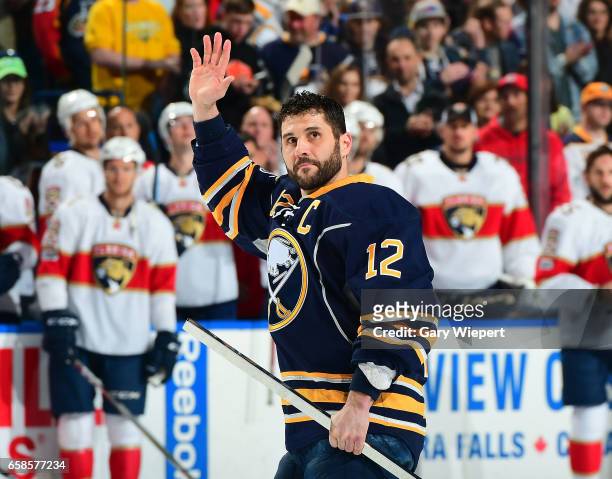 Brian Gionta of the Buffalo Sabres waves during ceremonies prior to his 1,000th career NHL game against the Florida Panthers at the KeyBank Center on...