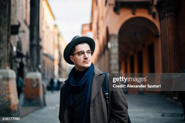 young man wearing hat and eyeglasses exploring bologna, italy - 33 arches stock pictures, royalty-free photos & images