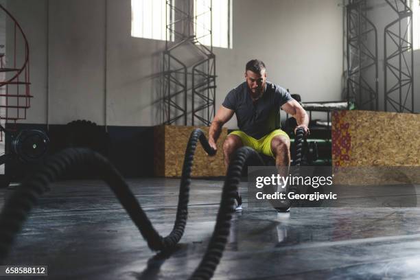 strengthen and sweat - battle rope stock pictures, royalty-free photos & images