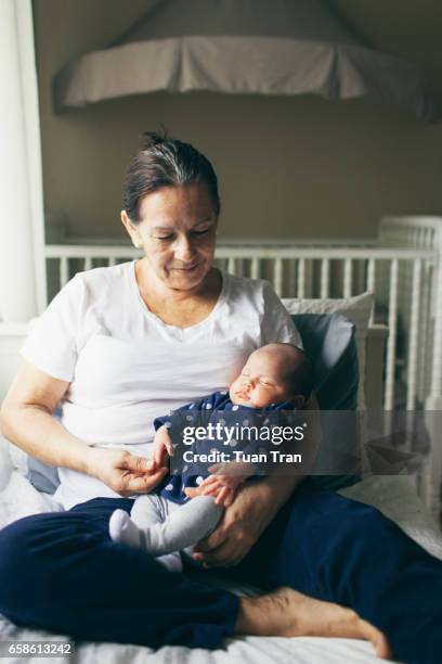 grandmother holding granddaughter - grandma sleeping stock pictures, royalty-free photos & images