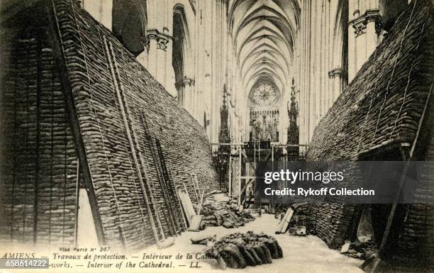 Postcard depicts the interior of Amiens Cathedral, protected by stacked sandbags during World War I, 1918.