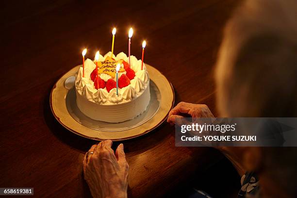 old woman and cake - senior woman birthday stock pictures, royalty-free photos & images