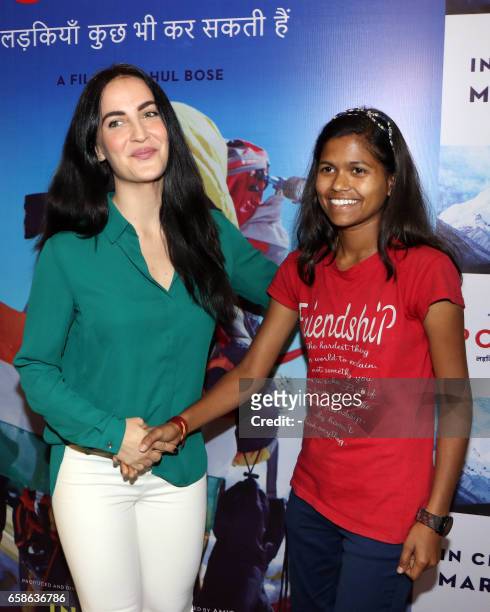 Indian Bollywood actress Elli Avram and Indian mountaineer Poorna Malavath attend the screening of upcoming Hindi film Poorna in Mumbai on March 27,...