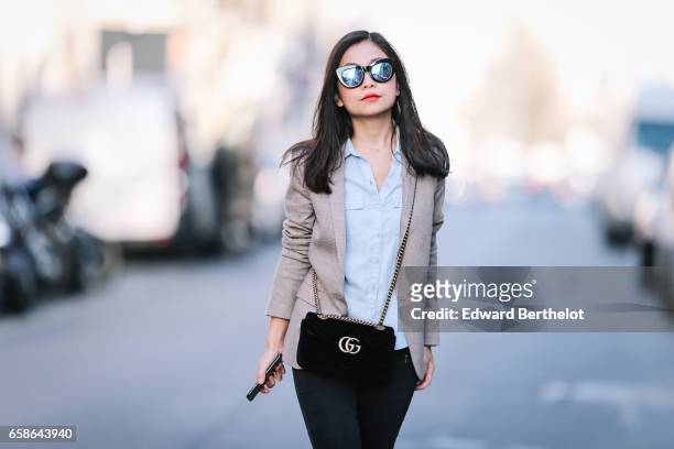 May Berthelot, Head of Legal at Videdressing.com and fashion blogger, wears black shoes, New Look pants, a Topshop blue shirt, an Asos beige blazer...
