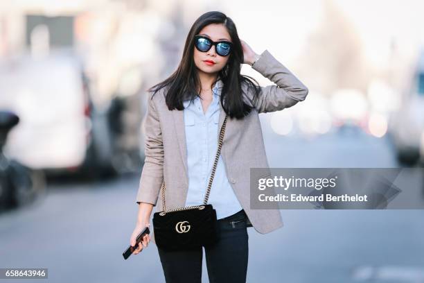 May Berthelot, Head of Legal at Videdressing.com and fashion blogger, wears black shoes, New Look pants, a Topshop blue shirt, an Asos beige blazer...