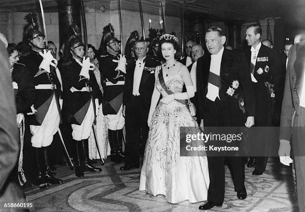 Queen Elizabeth II is escorted by French President René Coty at a gala performance at the Paris Opera during a state visit to France, 8th April 1957....