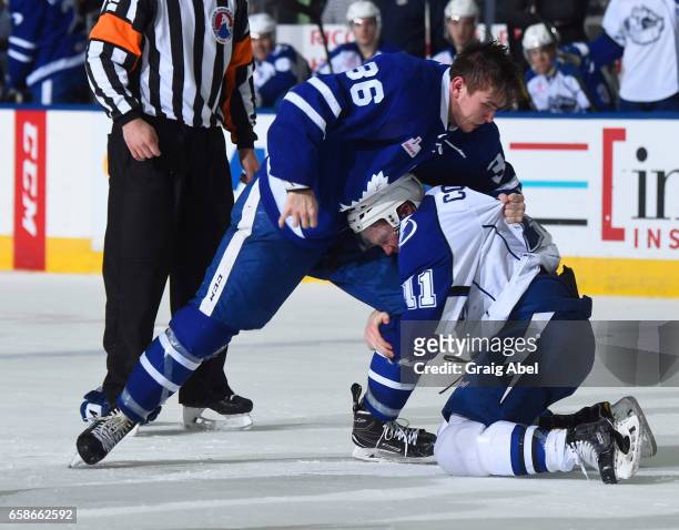 Kirby Rychel of the Toronto Marlies battles with Erik Condra of the Syracuse Crunch on March 26, 2017 at Ricoh Coliseum in Toronto, Ontario, Canada.