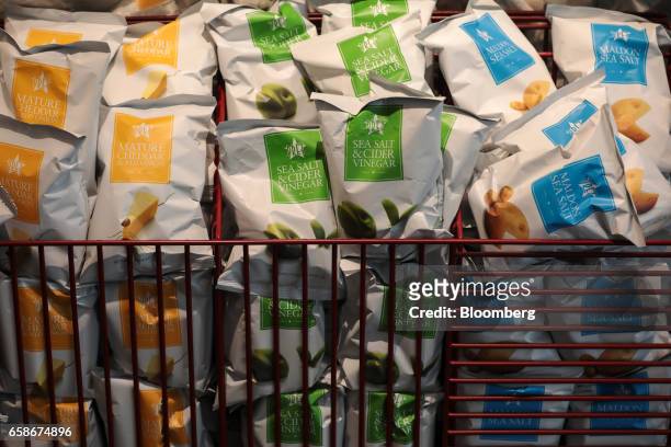 Bags of crisps sit in baskets inside a branch of food retailer Pret a Manger Ltd. In London, U.K., on Monday, March 27, 2017. Food chain Pret a...