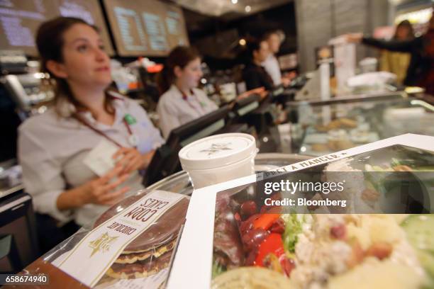 Salad box and chocolate corn cakes sit on a counter as employees serve customers inside a branch of food retailer Pret a Manger Ltd. In London, U.K.,...