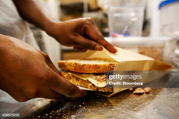 Chef prepares a toasted sandwich in the kitchen of a branch of food retailer Pret a Manger Ltd. In London, U.K., on Monday, March 27, 2017. Food...