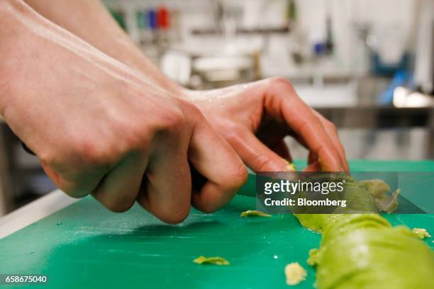 Chef slices avocado in the kitchen of a branch of food retailer Pret a Manger Ltd. In London, U.K., on Monday, March 27, 2017. Food chain Pret a...