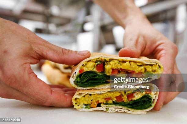 Chef prepares a sandwich wrap in the kitchen of a branch of food retailer Pret a Manger Ltd. In London, U.K., on Monday, March 27, 2017. Food chain...