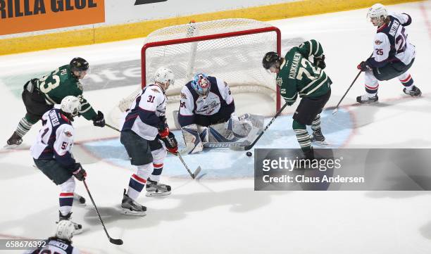 Michael DiPietro of the Windsor Spitfires stops Janne Kuokkanen of the London Knights during Game Two of the OHL Western Conference Quarter Finals at...