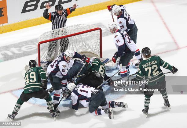 Max Jones of the London Knights tries to jam a puck past a fallen Michael DiPietro of the Windsor Spitfires during Game Two of the OHL Western...