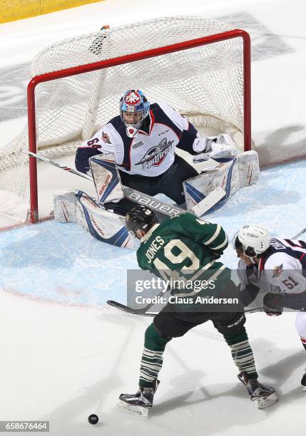 Michael DiPietro and Jalen Chatfield of the Windsor Spitfires defend against Max Jones of the London Knights during Game Two of the OHL Western...