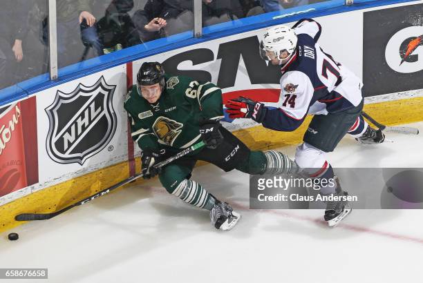 Sean Day of the Windsor Spitfires skates knocks Mitchell Stephens of the London Knights into the boards during Game Two of the OHL Western Conference...