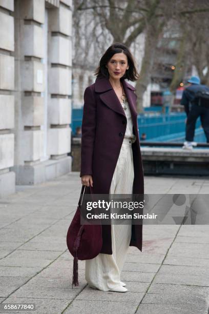 Fashion consultant Hikari Yokoyama wears a Mulberry coat, top and trousers and an Altuzarra bag on day 3 of London Womens Fashion Week Autumn/Winter...