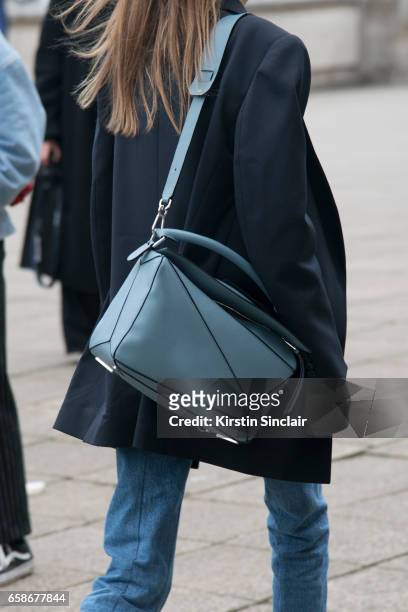 Guest wears a Loewe bag on day 3 of London Womens Fashion Week Autumn/Winter 2017, on February 19, 2017 in London, England.