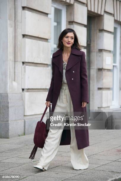 Fashion consultant Hikari Yokoyama wears a Mulberry coat, top and trousers and an Altuzarra bag on day 3 of London Womens Fashion Week Autumn/Winter...